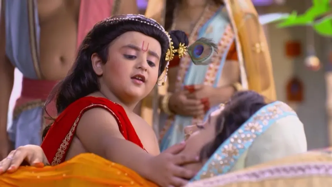 Krishna sings a song for an unconscious Yashoda 