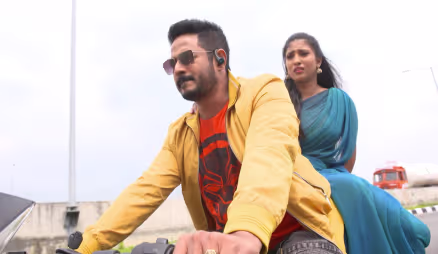 Vasundhara and Arjun on a motorbike - Gokulathil Seethai