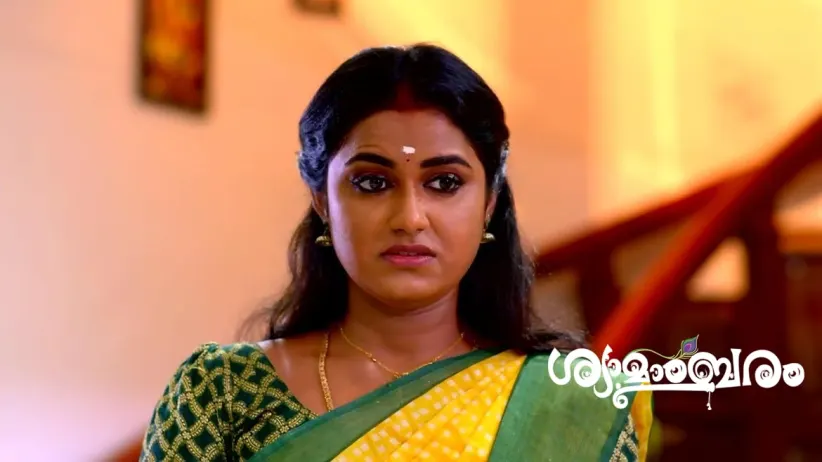 Vasudevan Hands the Prasadam to Shyama