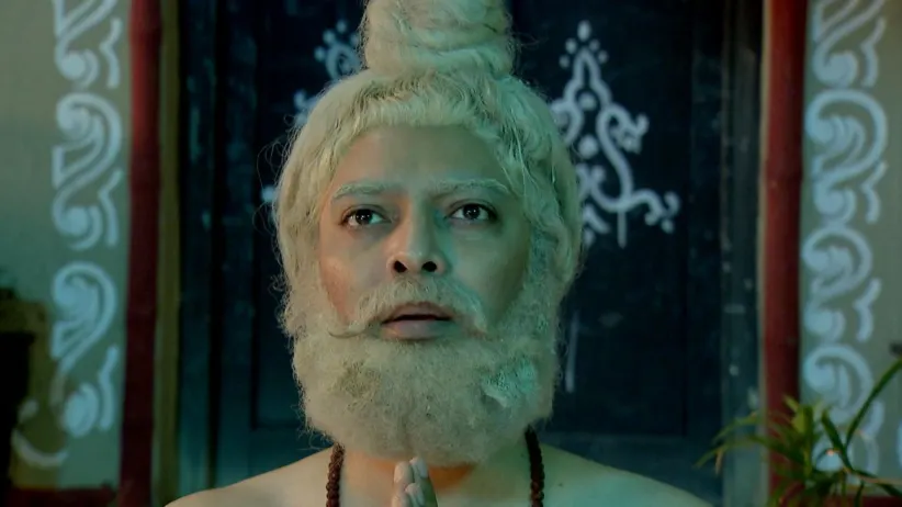 Lokenath sits on a wooden throne - Joy Baba Lokenath