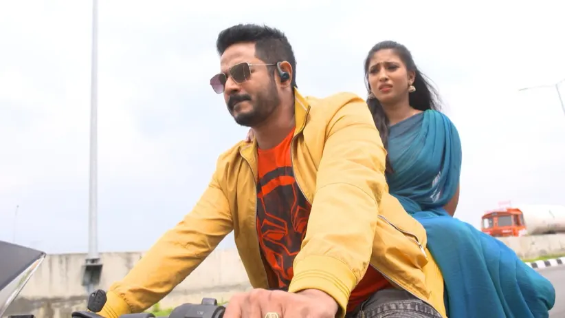 Vasundhara and Arjun on a motorbike - Gokulathil Seethai